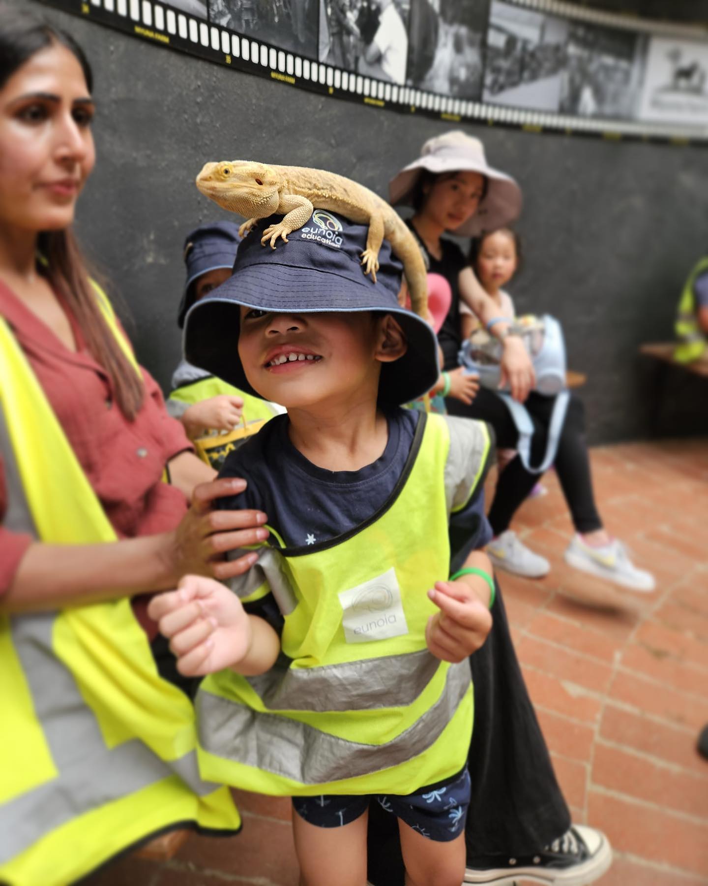 Smiling kinder child in a sun hat and hi-vis vest